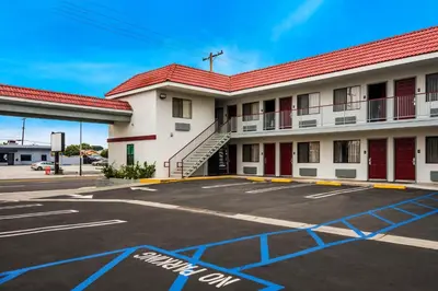 an empty parking lot in front of a hotel at Red Roof Inn Carson - Wilmington, CA in Wilmington