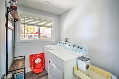 a laundry room with a washing machine and a window at Chic Running Springs Forest Cabin with Deck! in Running Springs