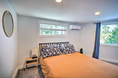 a bedroom with a bed and a window at Chic Running Springs Forest Cabin with Deck! in Running Springs