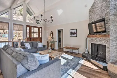 a living room with a couch and a fireplace at Stunning Lake Arrowhead Cabin with Lake Views! in Lake Arrowhead