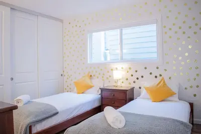 two beds in a small room with a window at Luxury Beachfront Condo - Endless Views - Surf 1 in Sunset Beach