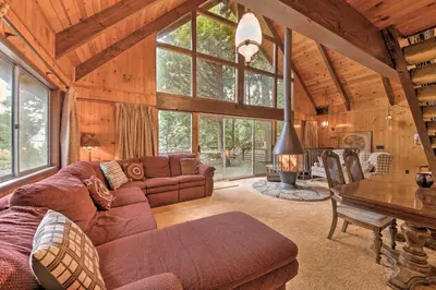 a living room with a couch and a table at Retro Cabin in Lake Arrowhead