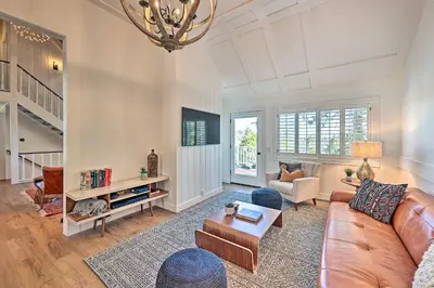a living room with a couch and a table at Ridgeline Retreat with Mountain Lake Views! in Lake Arrowhead