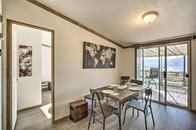 a dining room with a table and a balcony at Views Views Views! in Wofford Heights