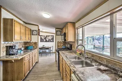a kitchen with wooden cabinets and a sink and a window at Views Views Views! in Wofford Heights