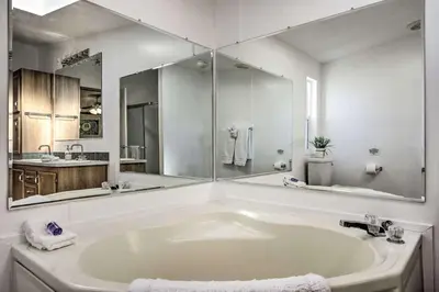 a bathroom with a large white tub with a large mirror at Views Views Views! in Wofford Heights