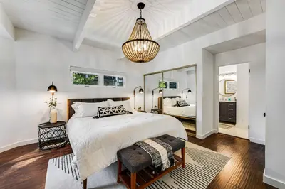 a bedroom with a large bed and a mirror at Paradise in the Palisades in Lake Arrowhead