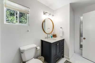 a bathroom with a toilet and a sink and a mirror at Paradise in the Palisades in Lake Arrowhead