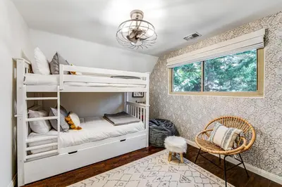 a bedroom with bunk beds and a window at Paradise in the Palisades in Lake Arrowhead