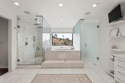 a bathroom with a tub and a shower with a window at The Hollywood Hills Crest Villa in Los Angeles