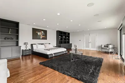 a bedroom with a bed and a table at The Hollywood Hills Crest Villa in Los Angeles