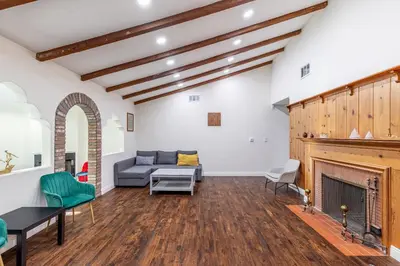a living room with a couch and a fireplace at Spacious Home with Garden & Pool in Northridge