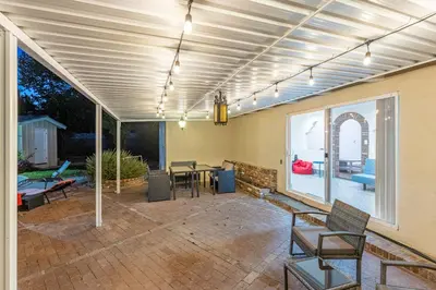 a covered patio with a table and chairs at Spacious Home with Garden & Pool in Northridge