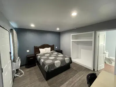 a bedroom with a bed and a large window at Cornett Motel in Los Angeles