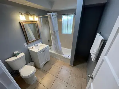 a bathroom with a toilet and a sink and a shower at Cornett Motel in Los Angeles