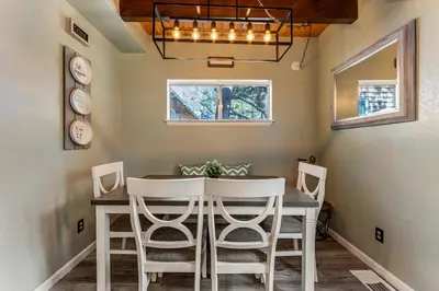 a dining room with a table and chairs at Blue Bird Beauty in Running Springs