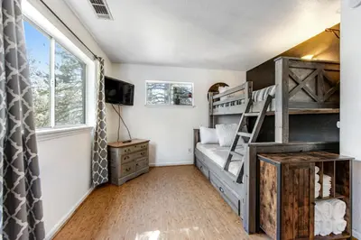a bedroom with bunk beds and a window at Blue Bird Beauty in Running Springs