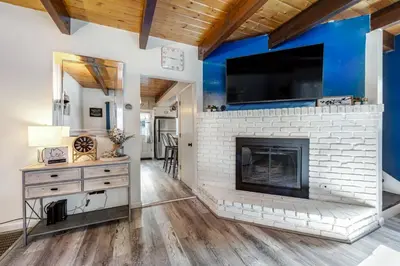 a living room with a fireplace and a tv at Blue Bird Beauty in Running Springs