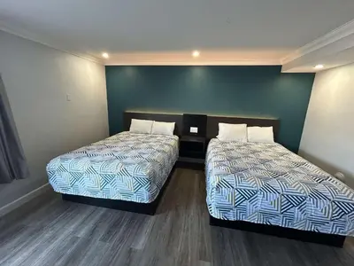 a room with two beds in a room at Motel 6 Buena Park, CA Anaheim Near Maingate Knotts in Buena Park