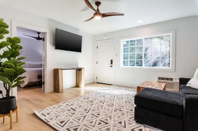 a living room with a couch and a ceiling fan at The Kingsley Hotel in Lake Arrowhead