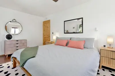 a bedroom with a large bed with two pink pillows at Chimney Peak Chalet #2048 by Big Bear Vacations in Big Bear City