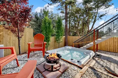 a backyard with a hot tub and a fire pit at Chimney Peak Chalet #2048 by Big Bear Vacations in Big Bear City
