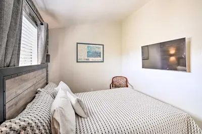 a small bedroom with a bed and a television at Crestline Cabin with Deck 1 Mi to Lake Gregory in Crestline