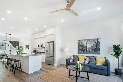 a living room and kitchen with a couch and a table at LA Harbor Home with Private Rooftop near #DTLA in San Pedro