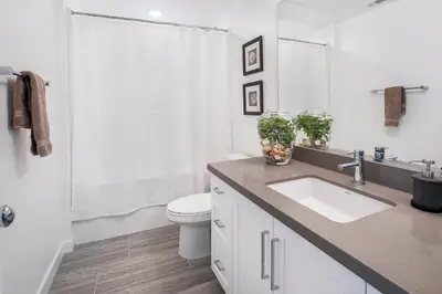 a white bathroom with a sink and a toilet at LA Harbor Home with Private Rooftop near #DTLA in San Pedro