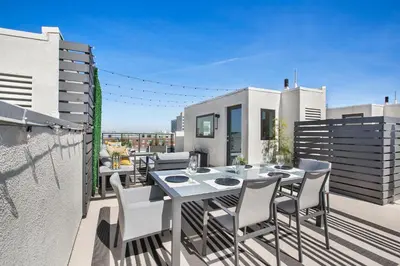 a patio with a table and chairs on a balcony at LA Harbor Home with Private Rooftop near #DTLA in San Pedro