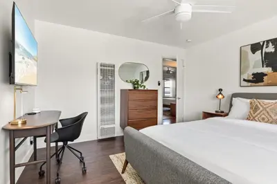a bedroom with a bed and a desk and a chair at Spacious Coastal Apartment in a Colorful Community - NRP22-00590 in Long Beach