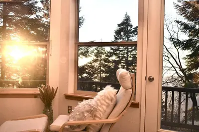 a rocking chair in front of a window at Sweet getaway in private Giant Sequoia Grove! in Springville