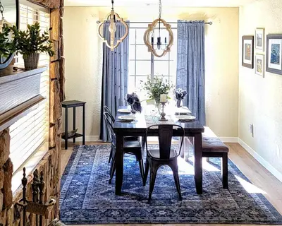 a dining room with a table and chairs and a window at Treehouse Cottage in Crestline