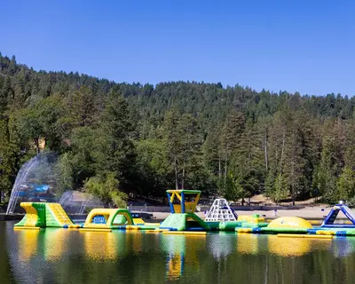 a group of inflatable play structures on a lake at Treehouse Cottage in Crestline