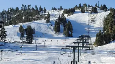 a snow covered ski slope with a ski lift at Treehouse Cottage in Crestline