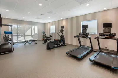 a gym with several exercise bikes and treadmills at Home2 Suites By Hilton Redlands in Redlands