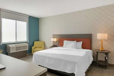 a hotel room with a large bed and a window at Home2 Suites By Hilton Redlands in Redlands