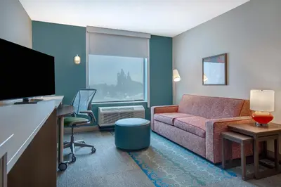 a living room with a couch and a tv at Home2 Suites By Hilton Garden Grove in Garden Grove