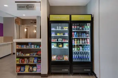 a refrigerator in a store with food and drinks at Home2 Suites By Hilton Garden Grove in Garden Grove