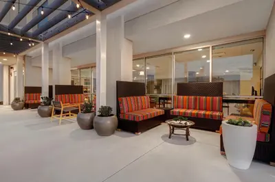 a lobby with two couches and a table and chairs at Home2 Suites By Hilton Garden Grove in Garden Grove