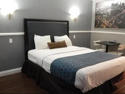 a hotel room with a large bed with a pillow at Hotel Salina in Long Beach