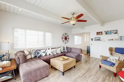 a living room with a couch and a ceiling fan at Brink of Paradise in Carpinteria
