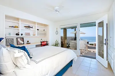 a bedroom with a bed and a view of the ocean at Brink of Paradise in Carpinteria