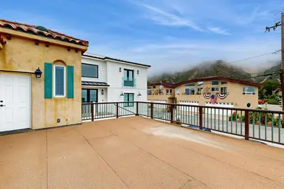 a house with a balcony with a fence at Brink of Paradise in Carpinteria