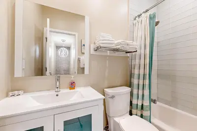 a bathroom with a sink and a toilet and a shower at Castles Reach in Anaheim
