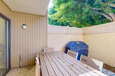 a wooden table with chairs and a blue bag at Castles Reach in Anaheim