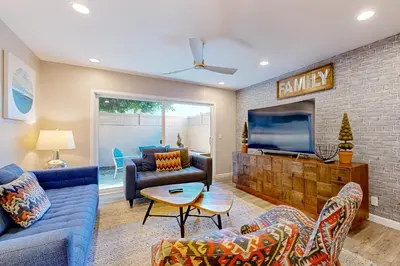 a living room with a couch and a tv at Castles Reach in Anaheim