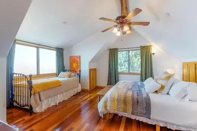 a bedroom with two beds and a ceiling fan at Million Dollar Mountain View in Crestline