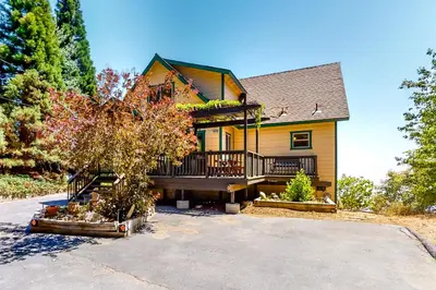 a house with a large porch and a driveway at Million Dollar Mountain View in Crestline