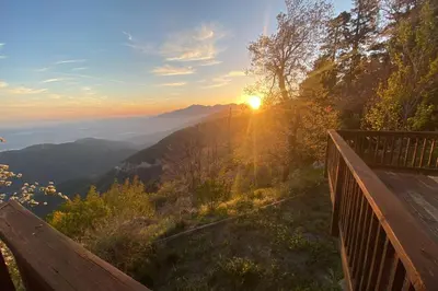 a view of the sun setting over a mountain at Million Dollar Mountain View in Crestline